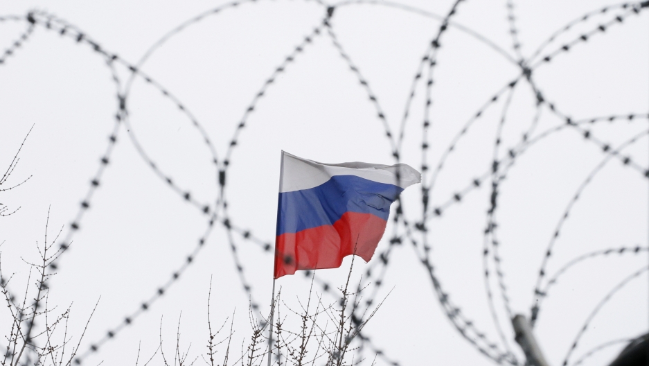 The Russian flag is seen through barbed wire as it flies on the roof of the Russian embassy in Kiev, Ukraine, March 26, 2018. The Russian flag is seen through barbed wire as it flies on the roof of the Russian embassy in Kiev, Ukraine, March 26, 2018.
