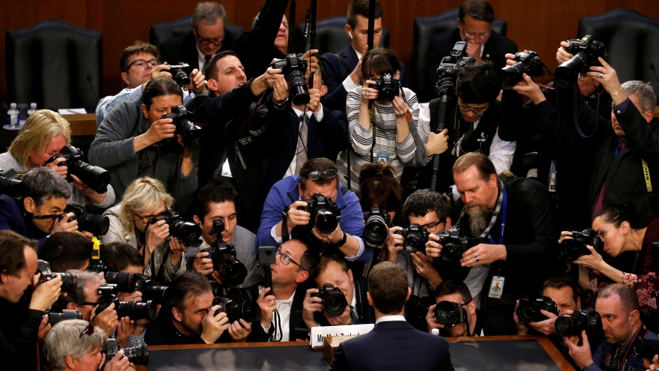Facebook CEO Mark Zuckerberg is surrounded by members of the media as he arrives to testify before a Senate Judiciary and Commerce Committees in Washington, DC. The picture show's the back of Facebook CEO Mark Zuckerberg who is surrounded by photographers.