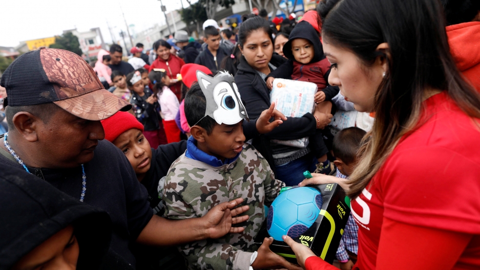 People hand out presents to children traveling with a caravan of migrants from Central America, near the San Ysidro checkpoint in Tijuana, Mexico April 30, 2018. People hand out presents to children traveling with a caravan of migrants from Central America, near the San Ysidro checkpoint in Tijuana, Mexico April 30, 2018.