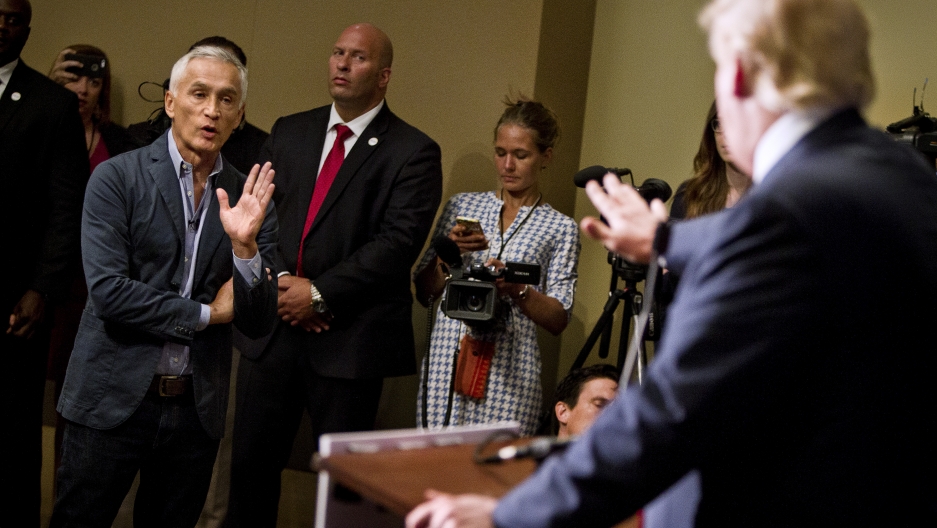 Then Republican presidential candidate Donald Trump spars with Univision reporter Jorge Ramos in Dubuque, Iowa, August 25, 2015. Ramos was removed from Trump's news conference. Then Republican presidential candidate Donald Trump spars with Univision reporter Jorge Ramos in Dubuque, Iowa, August 25, 2015. Ramos was removed from Trump's news conference.