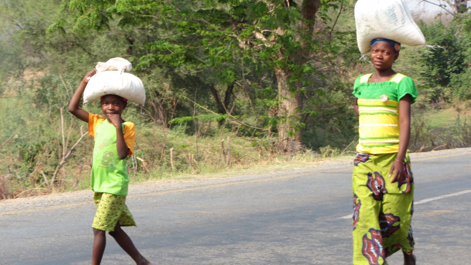 Zambians walking near their village