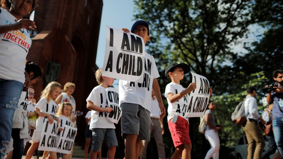 Children carry signs during a march to mark ìthe court-ordered deadline for the Trump Administration to reunify thousands of families separated at the border, in Washington DC, July 26, 2018. Children carry signs during a protest march in Washington DC, that read 'I am a child.'