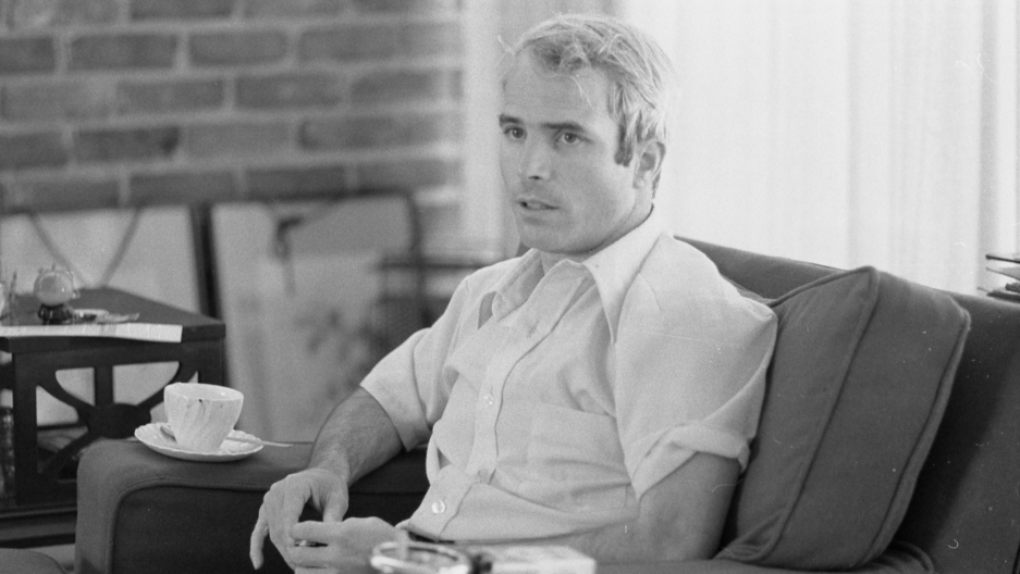 US Navy Lt. Cmdr. John McCain in 1973, being interviewed about his experiences as a prisoner of war during the war in Vietnam. John McCain is shown in a blakc and white photographer in 1973, being interviewed about his experiences as a prisoner of war during the war in Vietnam.