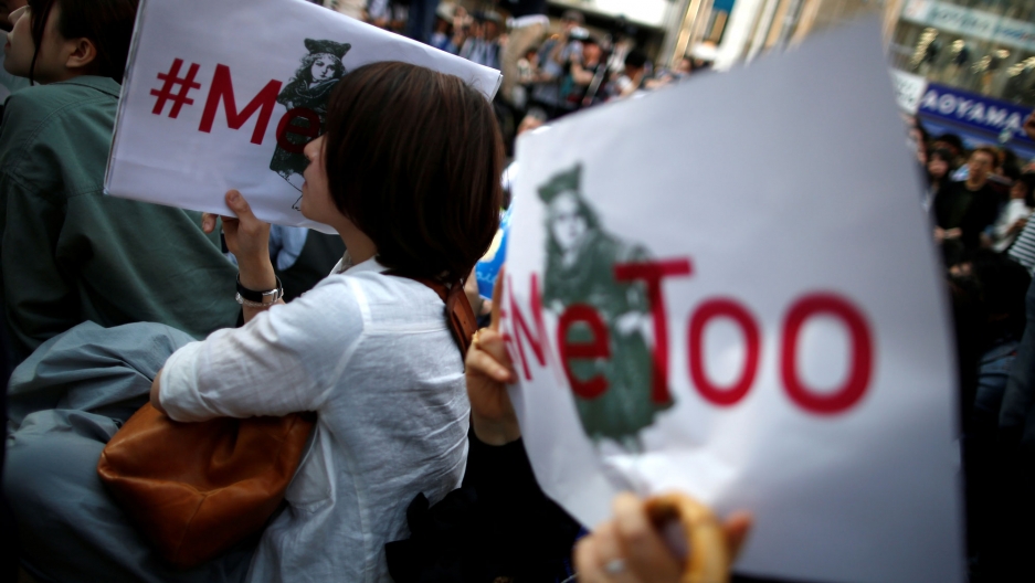 Protesters hold placards reading "#MeToo" during a rally against sexual harassment at Shinjuku shopping and amusement district in Tokyo, Japan, April 28, 2018. Protesters are shown holding white placards with red lettering reading "#MeToo" during a rally against sexual harassment in Tokyo, Japan.