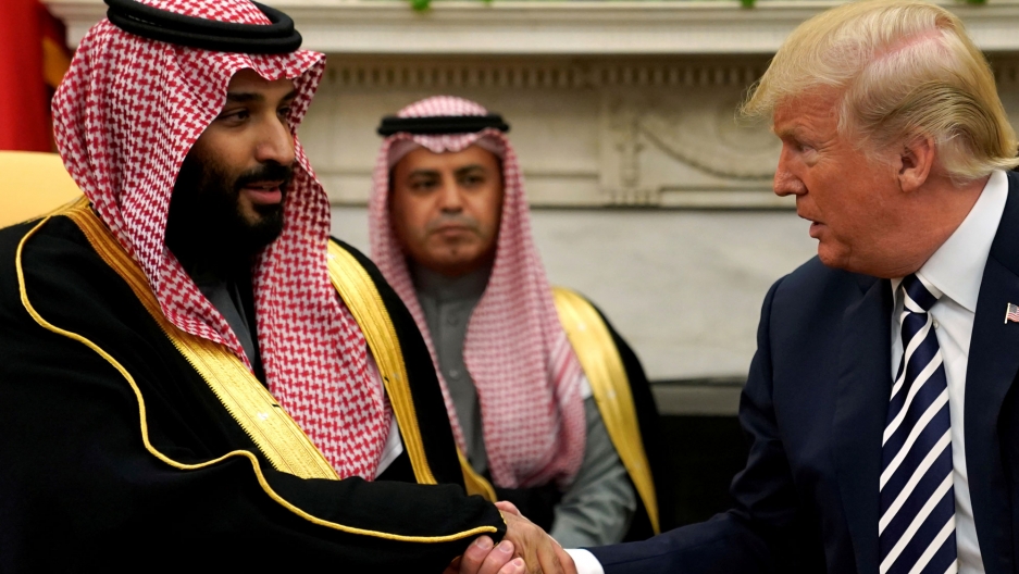 US President Donald Trump shakes hands with Saudi Arabia's Crown Prince Mohammed bin Salman in the Oval Office, March, 2018. US President Donald Trump is shown shaking hands with Saudi Arabia's Crown Prince Mohammed bin Salman in a medium framed photograph.
