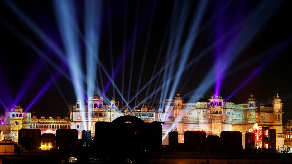 A view of the illuminated City Palace that is colored with different lights
