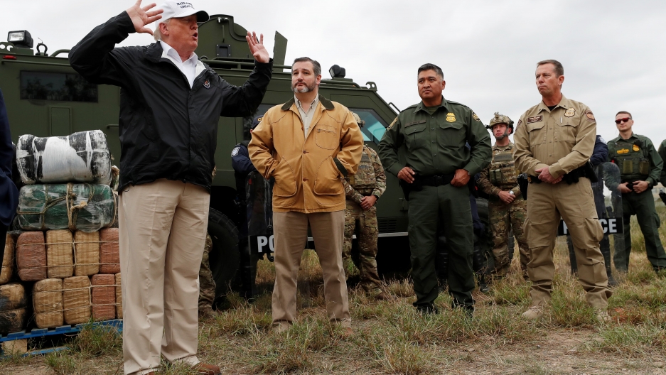 President Donald Trump speaks to reporters as he stands in front of a helicopter, next to Ted Cruz