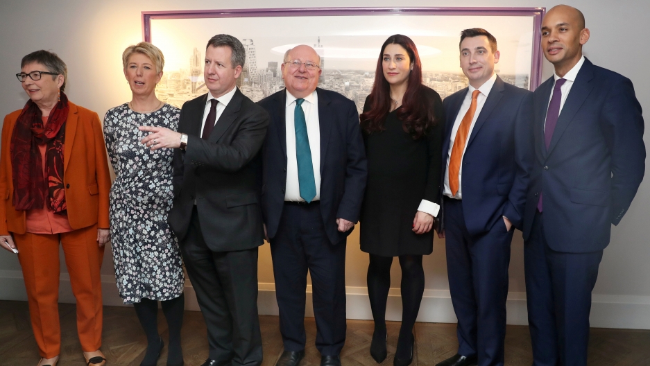 four men and three women pose for a picture