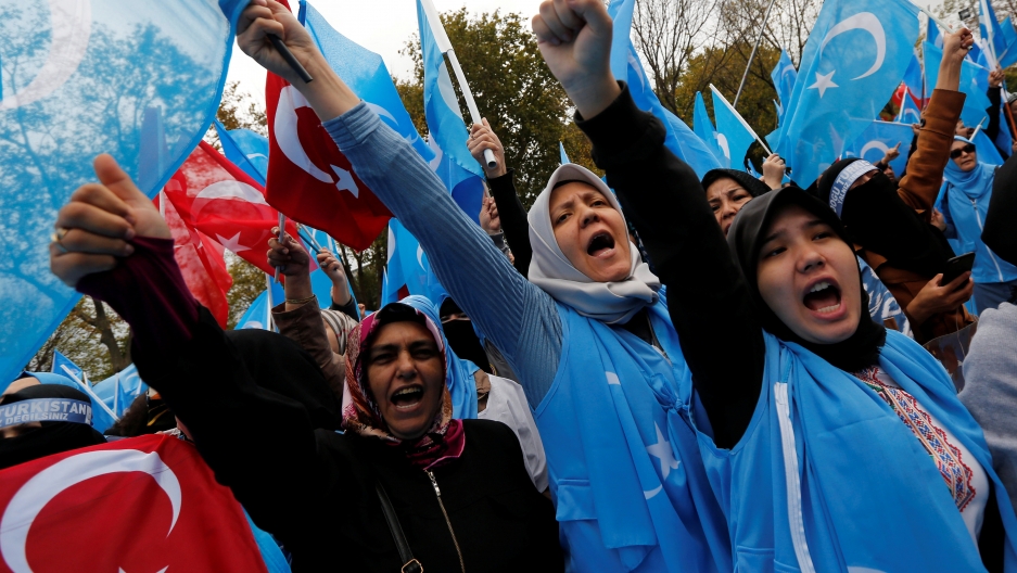 Demonstrators wave Turkish and East Turkestan flags as they shout slogans during a protest against China, in Istanbul, Turkey November 6, 2018.