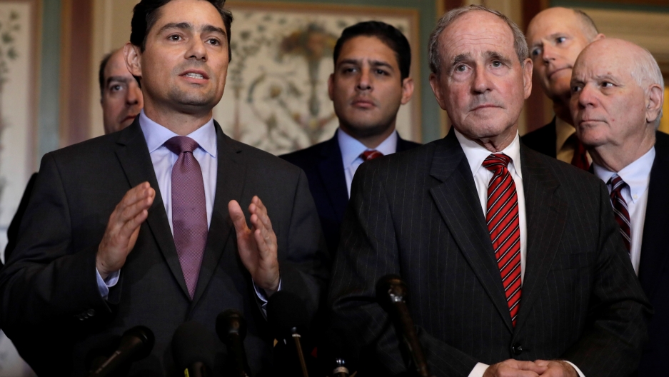 Carlos Alfredo Vecchio gestures while standing next to Senator Jim Risch
