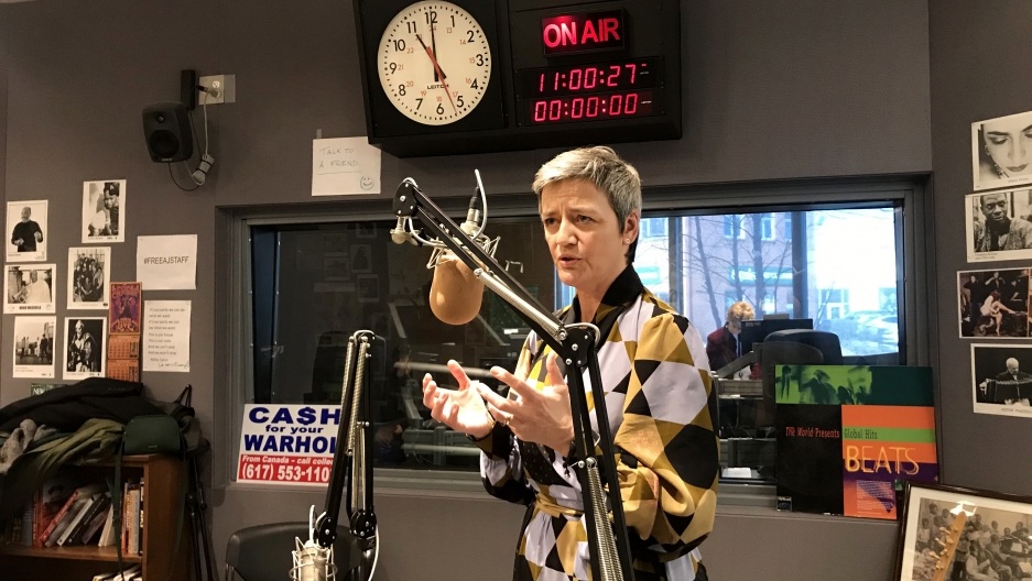 Vestager speaking about EU regulations. A women speakers into a microphone inside a recording studio.
