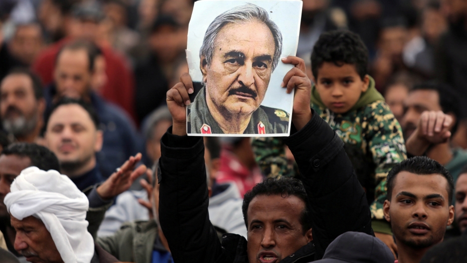 A man holds a poster of eastern Libyan military commander Khalifa Haftar 
