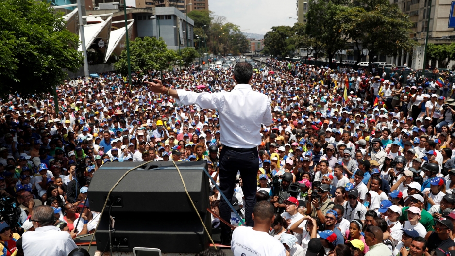 Venezuelan opposition leader Juan Guaidó speaks to supporters Venezuelan opposition leader Juan Guaidó is photographed from behind speaking out to hundreds of supporters.