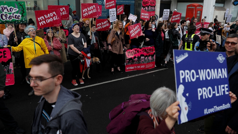 Pro-abortion and anti-abortion activists take part in recent March For Life event in London, Britain. Pro-abortion and anti-abortion demonstrators are shown with colorful placards arguing their position.
