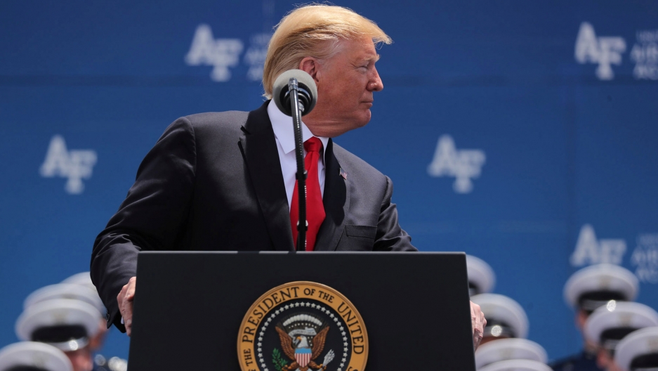 US President Donald Trump pauses while delivering the commencement address at the US Air Force Academy, May 30, 2019. US President Donald Trump is shown looking to his left while standing behind a podium with the US presidential seal on it.