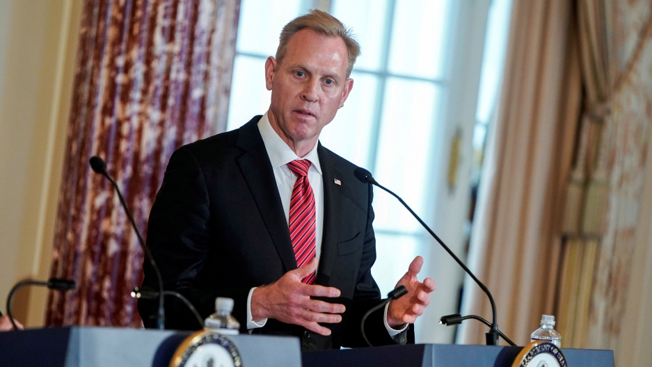 Acting US Secretary of Defense Patrick Shanahan speaks to the media in Washington, April 2019. Acting US Secretary of Defense Patrick Shanahan is shown standing behind a podium with a microphone, looking to his right.