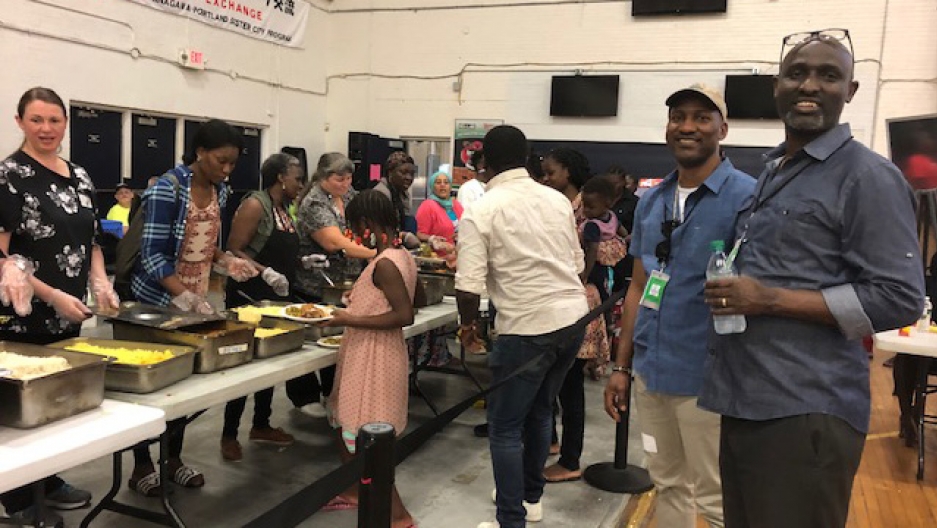  Claude Rwaganje and colleague at an event aiding asylum seekers in Portland, Maine 