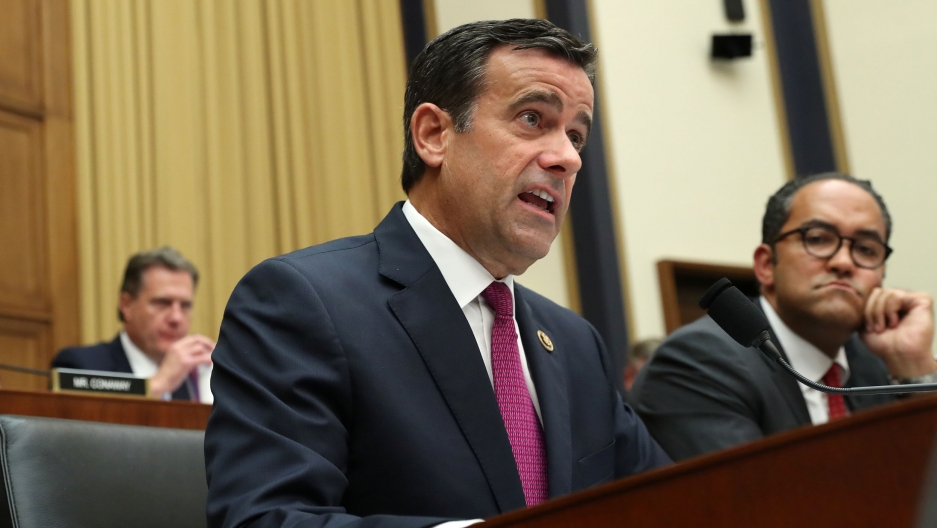 Rep. John Ratcliffe questions former special counsel Robert Mueller during a House intelligence committee hearing in Washington, July 24, 2019. Rep. John Ratcliffe is shown speaking behind a microphone and wearing a blue suit coat with a pink tie.