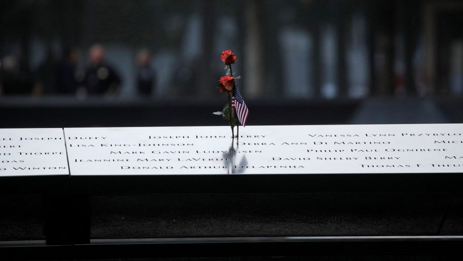 A flower sits atop the engraved names on a section of the 9/11 memorial in New York City