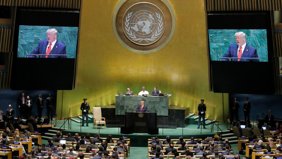 US President Donald Trump addresses the 74th session of the United Nations General Assembly at UN headquarters in New York City, Sept. 24, 2019. US President Donald Trump is shown on stage speaking at a black podium with live TV projections of him on either side.
