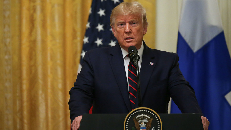 US President Donald Trump addresses a joint news conference with Finland's President Sauli Niinisto at the White House. US President Donald Trump is shown standing at a podium with a seal for the US president.