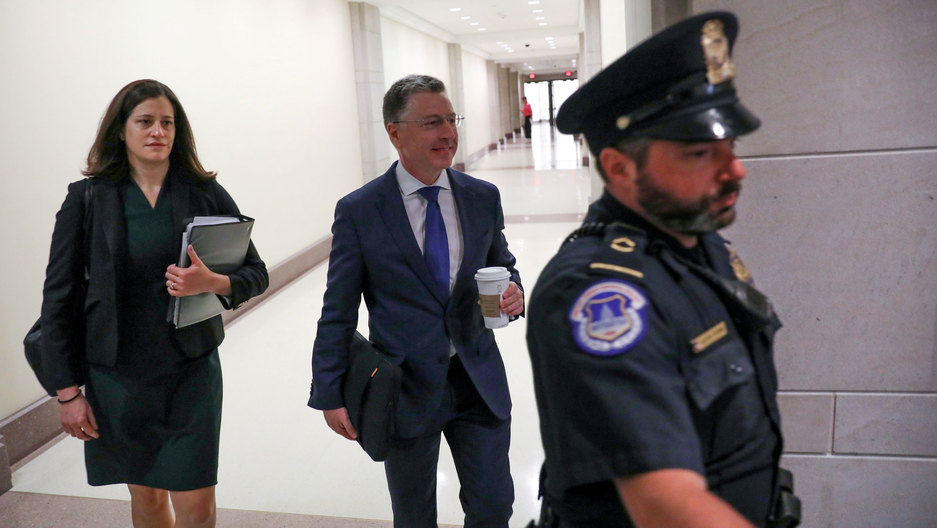 Kurt Volker, US President Donald Trump's former envoy to Ukraine, arrives at the House of Representatives as part of the impeachment inquiry into the president's dealings with Ukraine, Oct. 3, 2019. Kurt Volker is shown wearing a suit, walking and holding a coffee cup.