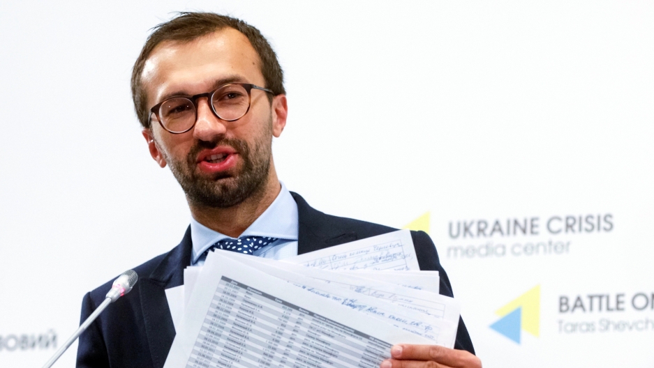 Ukrainian lawmaker Sergii Leshchenko displays papers from secret ledgers belonging to Party of Regions of former Ukraine's President Viktor Yanukovich during a news conference in Kyiv, Ukraine, Aug. 19, 2016. Ukrainian lawmaker