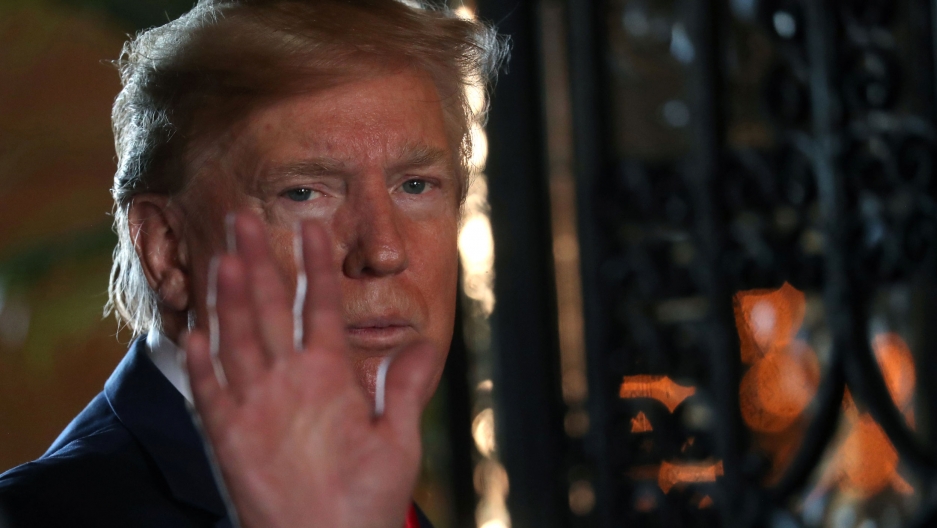 US President Donald Trump waves to the news media after participating in a video teleconference in Palm Beach, Florida, on Dec. 24, 2019. US President Donald Trump is shown in a close-up photo waving.