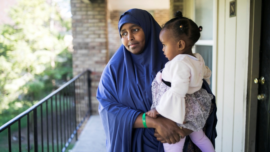 Ramlo Ali Noor, whose immediate family is affected by the Trump administration's cap on refugee numbers, poses at her apartment with her daughter Sumayo in Columbus, Ohio, on Sept. 27, 2019.