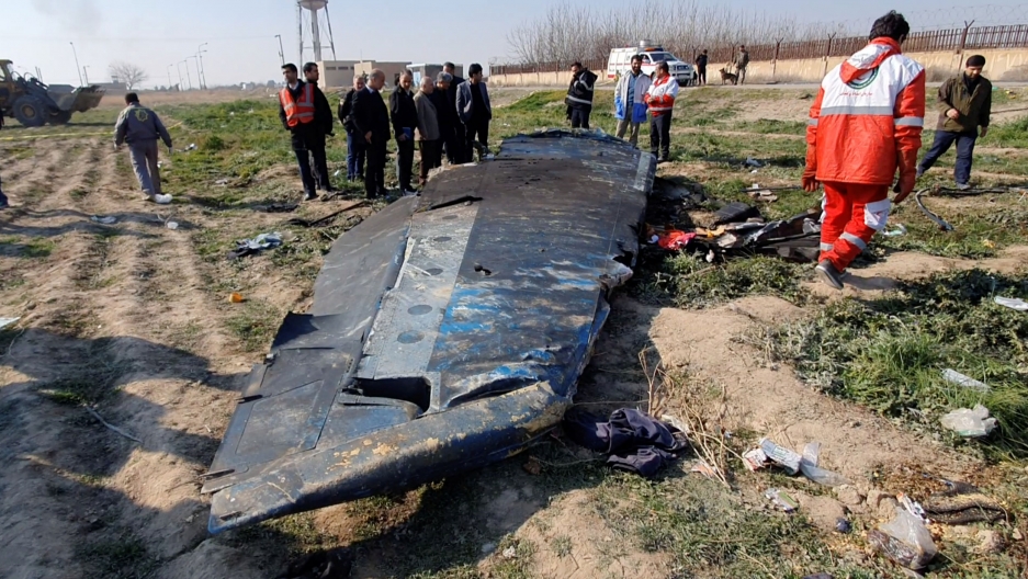 General view of the debris of the Ukraine International Airlines flight PS752 that crashed after take-off from Iran's Imam Khomeini Airport, on the outskirts of Tehran, Iran, Jan. 8, 2020 is seen in this screen grab obtained from a social media video. A part of a wing from Ukraine International Airlines flight PS75 is shown in a field with emergency workers standing by.