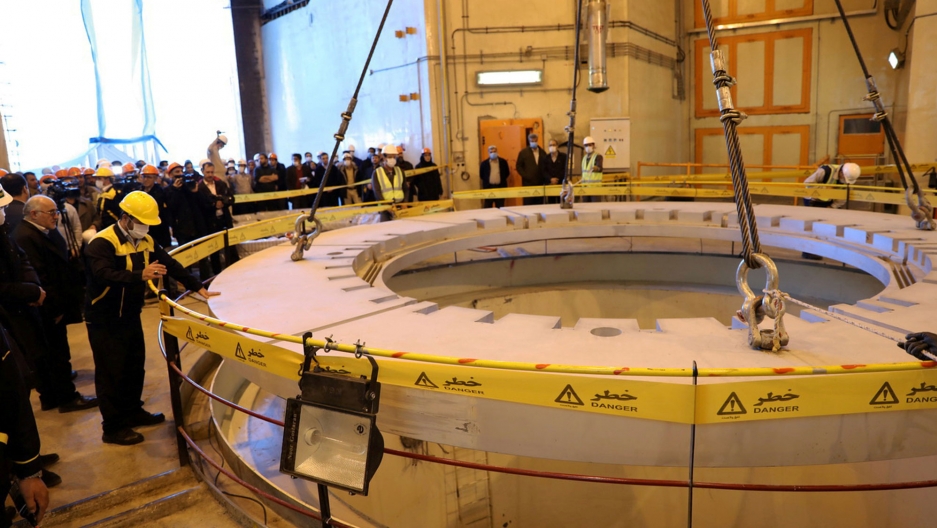 Members of the media and officials tour the water nuclear reactor at Arak, Iran, Dec. 23, 2019. Several people wearing hard hats are shown looking at nuclear equipment.