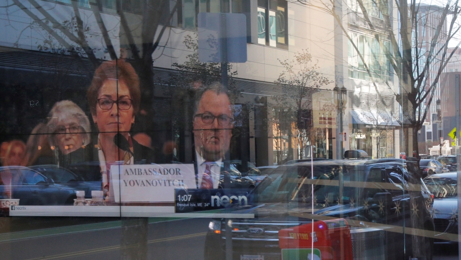 A television in a bank shows former US Ambassador to Ukraine Marie Yovanovitch during coverage of the House Intelligence Committee hearing in the impeachment inquiry into US President Donald Trump in Boston, MA, Nov. 15, 2019. A television with former US Ambassador to Ukraine Marie Yovanovitch on screen is shown through a wall of glass.