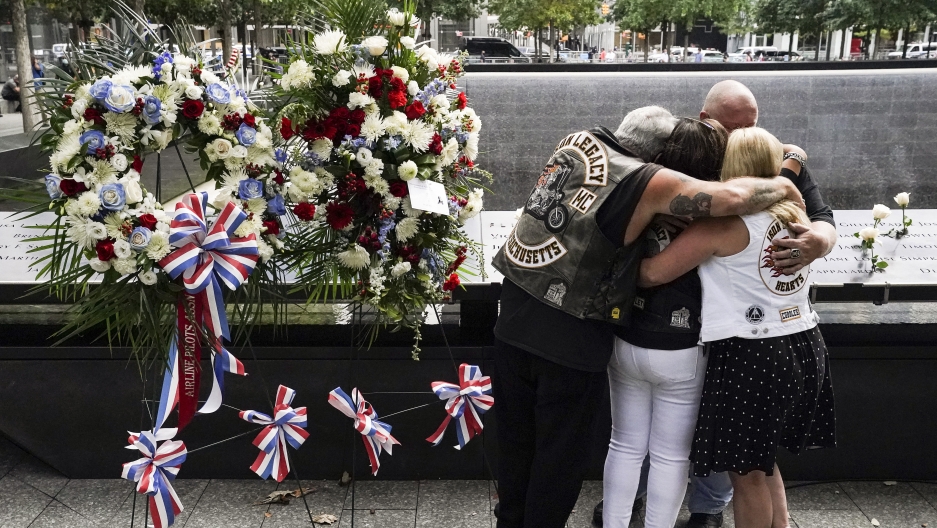 Mourners hug beside the names of the deceased Jesus Sanchez and Marianne MacFarlane at the National September 11 Memorial and Museum, Sept. 11, 2020, in New York. Mourners hug beside the names of the deceased Jesus Sanchez and Marianne MacFarlane at the National September 11 Memorial and Museum, Sept. 11, 2020, in New York.