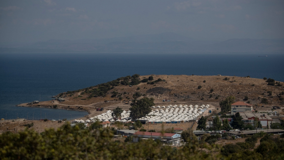 A view of the temporary camp for refugees and migrants near Mytilene, on the northeastern island of Lesbos, Greece, Sept. 13, 2020. A view of a newly constructed camp for asylum-seekers with dozens of rows of white tents and the Aegan Sea in the distance.