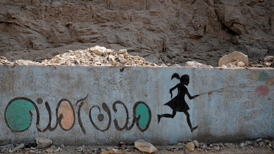 In this file photo, a mural depicting messages against sexual harassment and reading "safe cities" in Arabic script is seen on a highway in Cairo, Egypt, Sept. 3, 2018.
