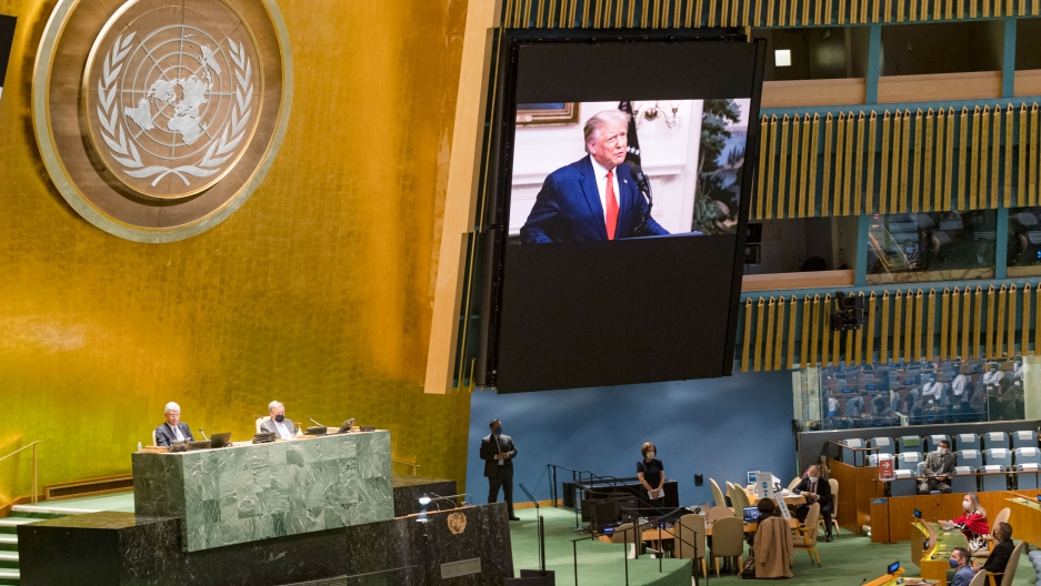 US President Donald Trump, shown on video screens as his pre-recorded message is played during the 75th session of the United Nations General Assembly, Sept. 22, 2020. US President Donald Trump, shown on a large video screen against a gold leaf wall and the United Nations symbol.