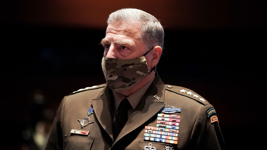 Chairman of the Joint Chiefs of Staff Gen. Mark Milley arrives early for a House Armed Services Committee hearing, July 9, 2020 in Washington. Chairman of the Joint Chiefs of Staff Gen. Mark Milley is shown wearing a camoflaged face mask and his military suit with medals across his chest.