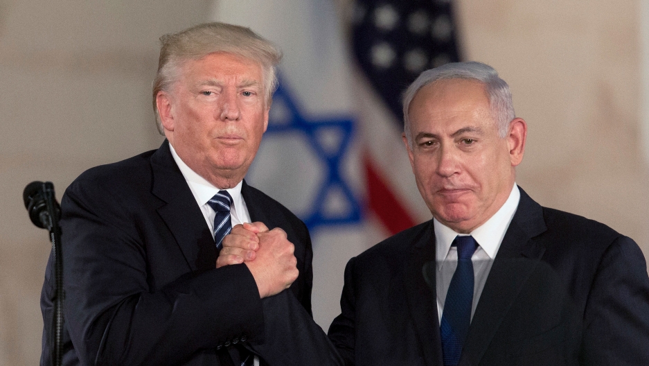 US President Donald Trump and Israeli Prime Minister Benjamin Netanyahu shake hands at the Israel museum in Jerusalem, May 23, 2017. US President Donald Trump and Israeli Prime Minister Benjamin Netanyahu are shown both wearing dark suits and in a tight handshake.