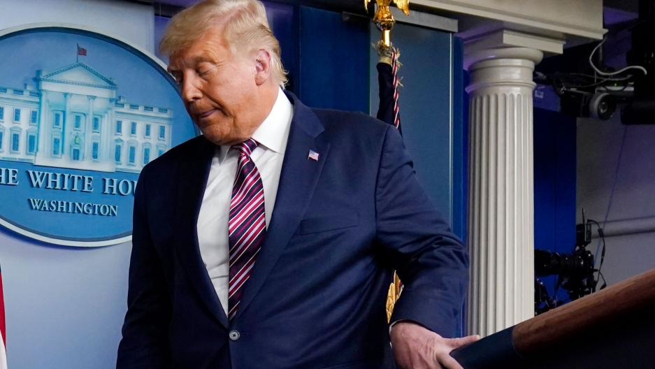 President Donald Trump leaves after speaking at the White House, Nov. 5, 2020. President Donald Trump is shown wearing a blue suit and stripped tie while turning and walking away from a podium.