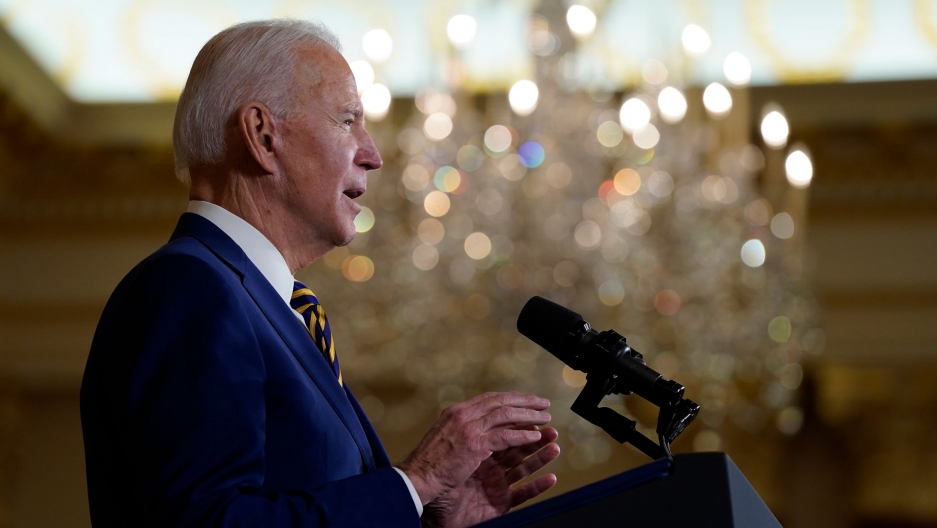 President Joe Biden speaks about foreign policy at the State Department, Feb. 4, 2021. President Joe Biden is shown in profile speaking at a podium with microphones and wearing a blue suit.