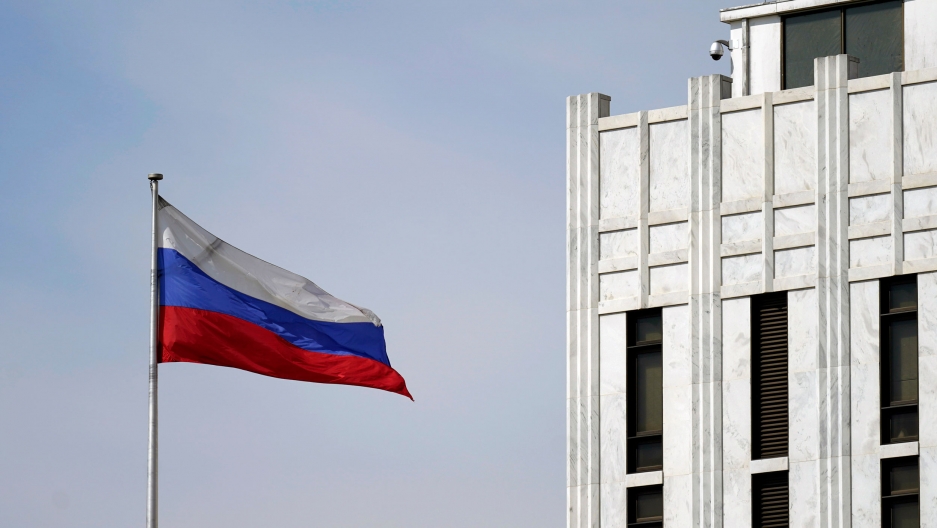 The Russian flag flies on the grounds of the Embassy of the Russian Federation in Washington, April 15, 2021. The white, blue and red horizontal stripes of the Russian flag is shown flying in front of the country's embassy building in Washington, DC.