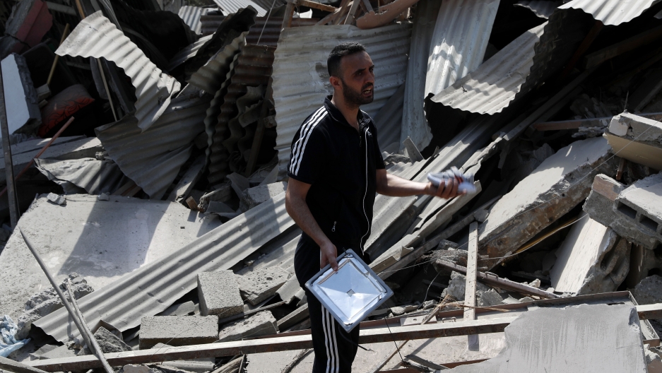 A man inspects the rubble of destroyed residential building, which was hit by Israeli airstrikes, in Gaza City A man inspects the rubble of destroyed residential building, which was hit by Israeli airstrikes, in Gaza City