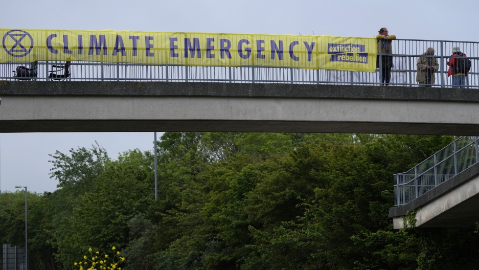 A climate banner covers the side of an overpass on a road leading to the G-7 summit near St. Ives, Cornwall, England, Thursday, June 10, 2021. A climate banner covers the side of an overpass on a road leading to the G-7 summit near St. Ives, Cornwall, England, Thursday, June 10, 2021.