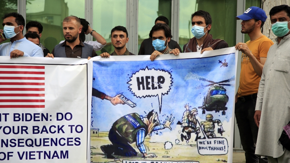 In this Friday, April 30, 2021, file photo former Afghan interpreters hold banners during a protest against the US government and NATO in Kabul, Afghanistan. In this Friday, April 30, 2021, file photo former Afghan interpreters hold banners during a protest against the US government and NATO in Kabul, Afghanistan.
