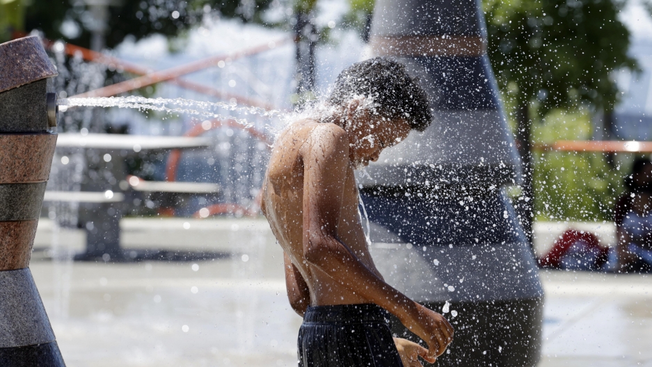 A young person cools off in the Yesler Terrace spray park during a heat wave hitting the Pacific Northwest, Sunday, June 27, 2021, in Seattle. Yesterday set a record high for the day with more record highs expected today and Monday. A young person cools off in the Yesler Terrace spray park during a heat wave hitting the Pacific Northwest, Sunday, June 27, 2021, in Seattle.