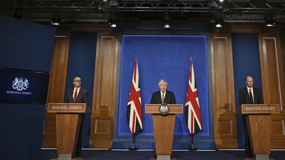 Britain's Prime Minister Boris Johnson, center, speaks during a media briefing on coronavirus in Downing Street, London, Monday, July 5, 2021. Britain's Prime Minister Boris Johnson, center, speaks during a media briefing on coronavirus in Downing Street, London, Monday, July 5, 2021.