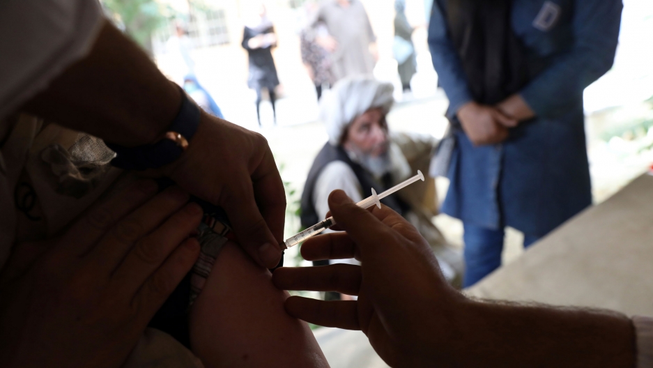 A woman receives the Johnson & Johnson COVID-19 vaccine at a vaccination center in Kabul, Afghanistan, Sunday, July 11, 2021. A woman receives the Johnson & Johnson COVID-19 vaccine at a vaccination center in Kabul, Afghanistan, Sunday, July 11, 2021.