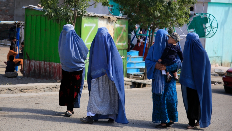 Afghan women walk on the road in Kabul, Afghanistan, Thursday, May 13, 2021. Afghan women walk on the road in Kabul, Afghanistan, Thursday, May 13, 2021.