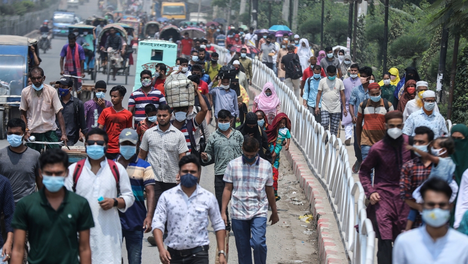 People wearing face masks as a precaution against the coronavirus leave the city to travel to their native places ahead of Eid al-Fitr in Dhaka, Bangladesh People wearing face masks as a precaution against the coronavirus leave the city to travel to their native places ahead of Eid al-Fitr in Dhaka, Bangladesh
