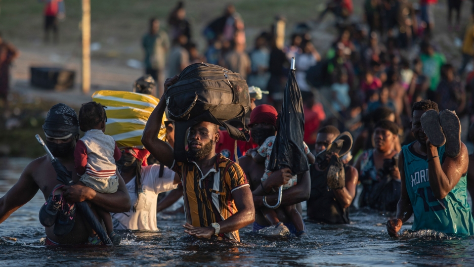 Migrants, many from Haiti, wade across the Rio Grande river from Del Rio, Texas, to return to Ciudad Acuña, Mexico, Monday, Sept. 20, 2021, to avoid deportation from the US. Migrants, many from Haiti, wade across the Rio Grande river from Del Rio, Texas, to return to Ciudad Acuña, Mexico, Monday, Sept. 20, 2021, to avoid deportation from the US.